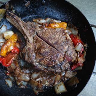 sizzling steak with colorful peppers and onions