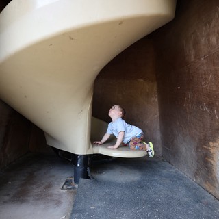 Young Child Climbing Curved Playground Slide at Fantasyland