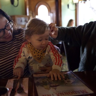 Family Moment Reading Together at Restaurant