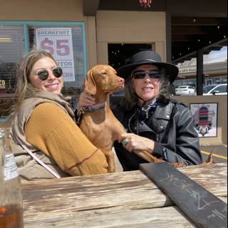 Two Women and a Pup Enjoy a Day by the Waterfront