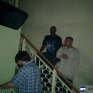 Three Men and a DJ on the Stairs