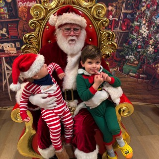 Two Children Visit Santa in His Ornate Golden Throne