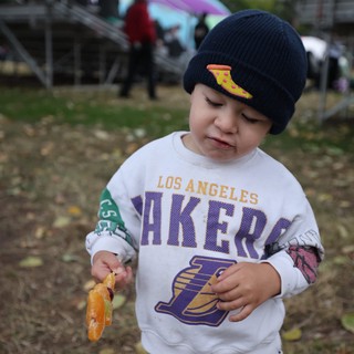 Young Lakers Fan Snacking at Outdoor Festival