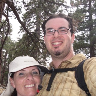 Couple Smiling During Mountain Hiking Adventure