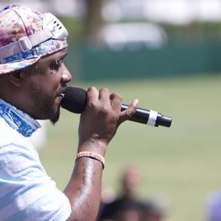 Man with Mic in Hat Performs at Coachella
