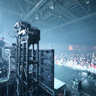 DJ Performs Before Massive Indoor Festival Crowd