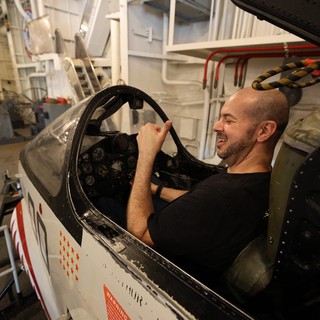Visitor Enjoying Vintage Aircraft Cockpit at USS Hornet Museum
