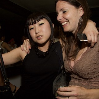 Two Friends Laughing Together at a Nightclub