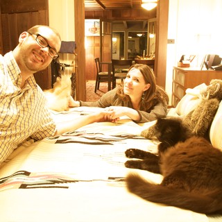 Couple Relaxing Together with Their Cats at Home