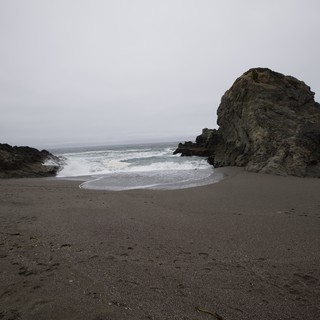 Moody Coastal Cove with Dramatic Sea Stack