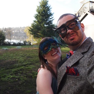 Masquerade Couple Posing by Lakeside Venue