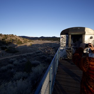 Desert Sunset at Futuristic Observation Platform with Face Sculpture