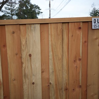 New Cedar Fence with Construction Company Sign