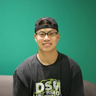 Smiling Teen in Black Hat and Glasses