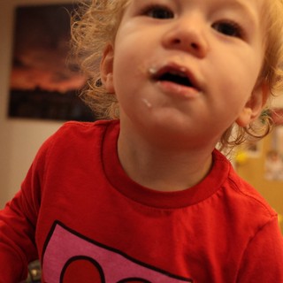 Curious Toddler in Red Shirt at Home