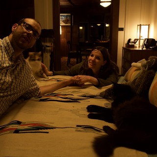 Couple Relaxing on Floor with Cats at Night