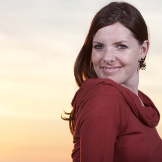Smiling Woman Glances Back at Golden Sunset