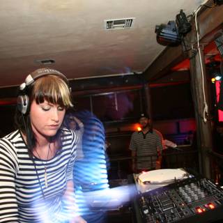 Striped Shirt DJ at Night Club
