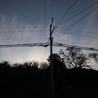 Silhouetted Power Lines Against Twilight Sky
