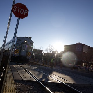 Train Crossing at Dusk with Stop Sign
