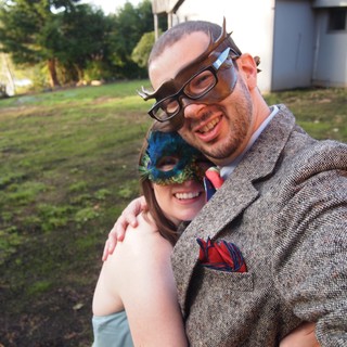 Masked Couple Embracing at Outdoor Masquerade Party