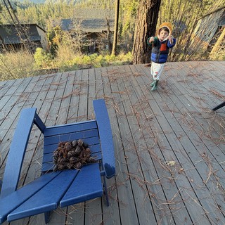 Young Explorer on Mountain Cabin Deck at Dusk