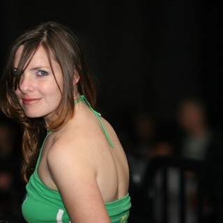 Woman in Green Halter Top Glances Back Playfully