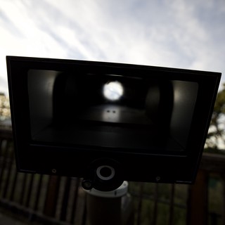 Silhouetted Vintage Camera Against Cloudy Sky