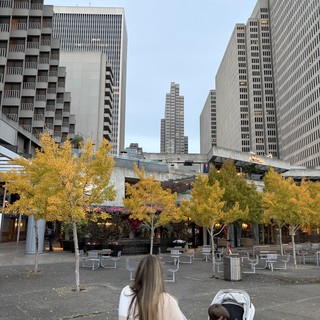 Mother and Child in Modern Urban Plaza