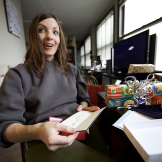 Joyful Woman Opens Christmas Card With Surprise