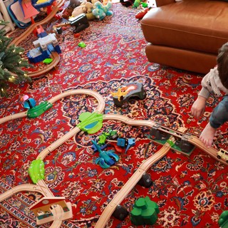 Child Playing with Wooden Train Set on Christmas