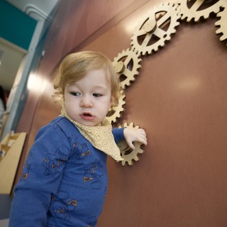 Curious Toddler Explores Interactive Gear Wall Display