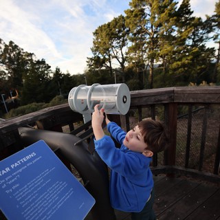 Young Explorer Using Star Pattern Viewer at Observatory Deck
