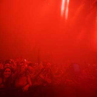 Red Spotlight on a Vibrant Concert Crowd