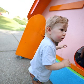 Young Child Playing at Colorful Playground Structure