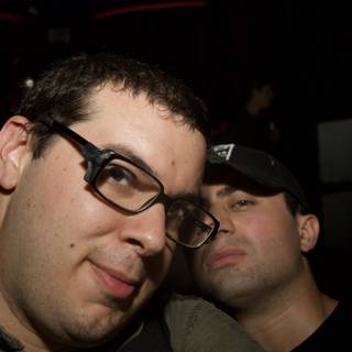 Two Glasses-Wearing Men Taking a Selfie at a Party