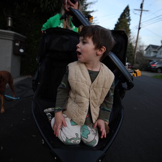Child in Adaptive Wheelchair on Evening Neighborhood Walk