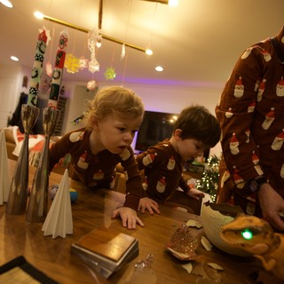 Children in Matching Pajamas Examining Christmas Decorations