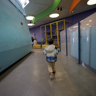 Child Exploring Colorful Modern Play Space Corridor