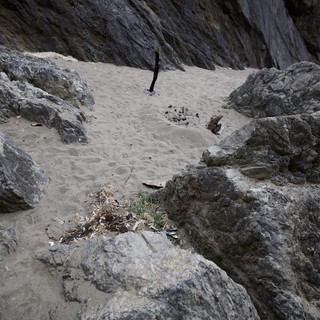 Rocky Cove Beach with Remnants of Campfire