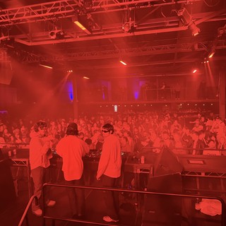 Electronic Music Event with Intense Red Stage Lighting