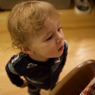 Toddler with Curly Blonde Hair at Christmas Gathering