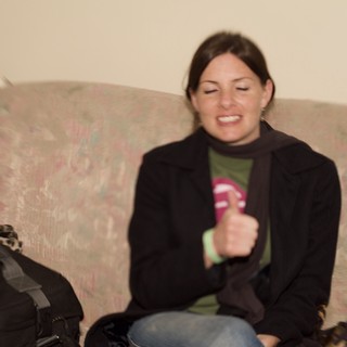 Woman Laughing Joyfully on Floral Sofa