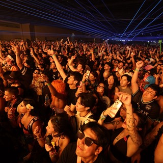 Massive Crowd Erupts Under Blue Laser Light Show