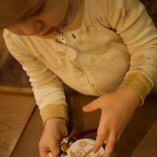 Toddler Decorating Christmas Ornament at Home