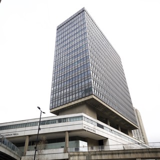 Brutalist Tower Rising Above London Wall Pedestrian Walkway