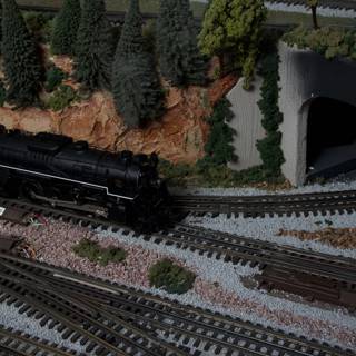 Miniature Train Chugging Through a Tunnel