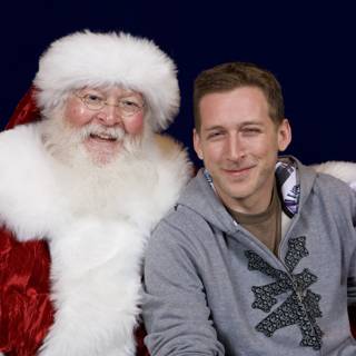 Cedrick O posing with Santa Claus at APC Christmas Party