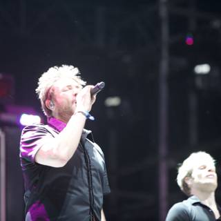 Two Men Rocking the Stage with Light and Sound