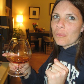Woman Enjoying Brandy in Cozy Living Room